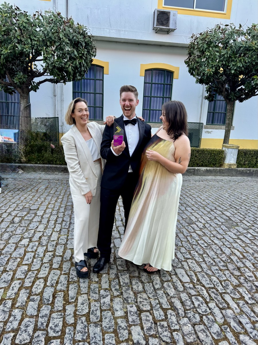 Matt Meazey holding the European Search Awards 2026 trophy in Porto with the MASAJ team